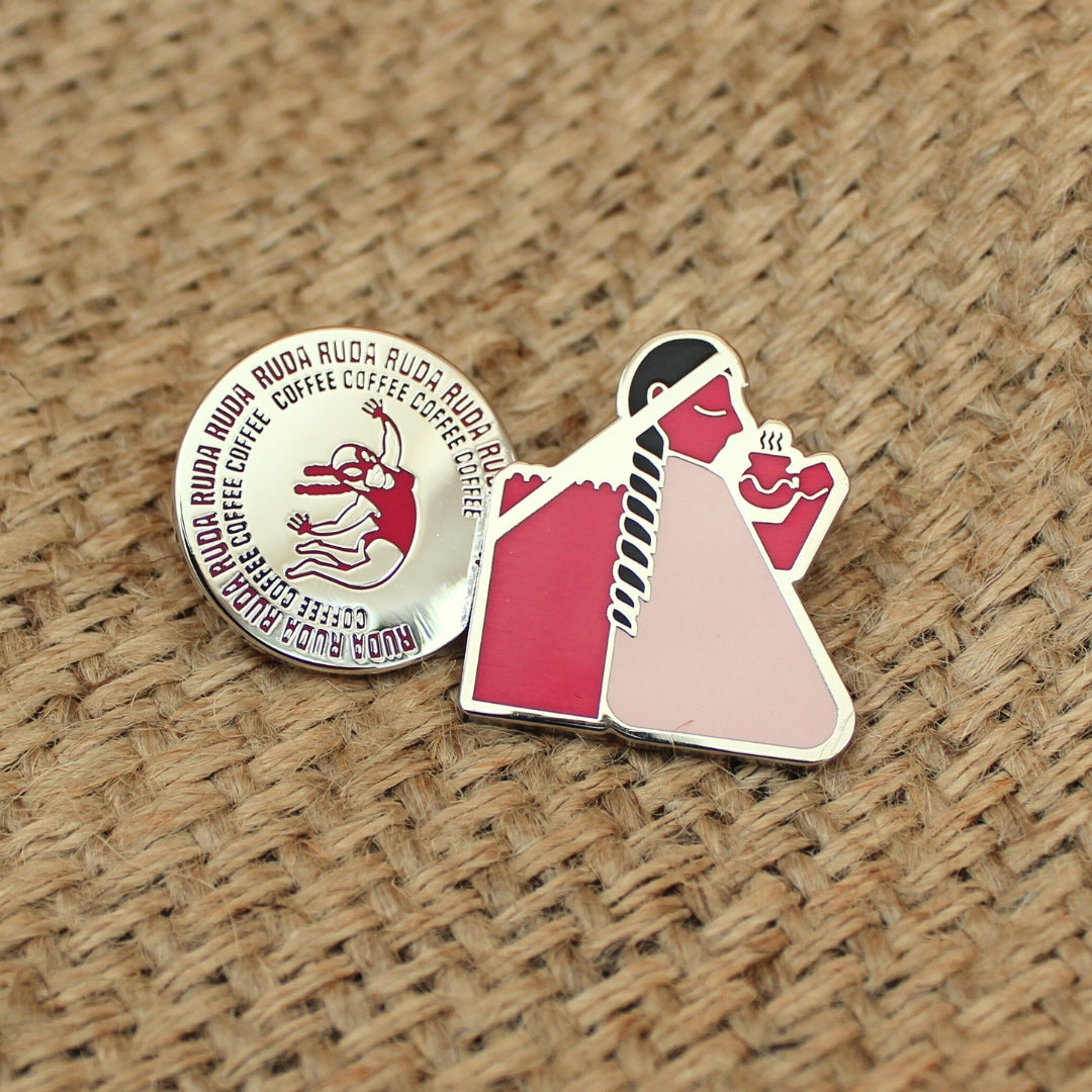 Two small round pins on a textured brown surface
