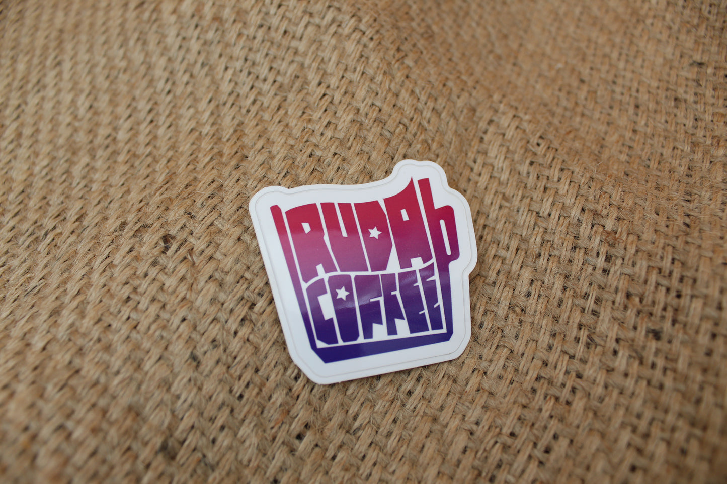 Sticker with colorful text on a textured brown background
